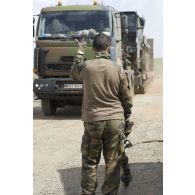 Un opérateur du Service des essences des armées (SEA) guide le placement d'un train routier porte chars (TR-PC 50) du 121e régiment du train (RT) pour son recomplètement en carburant à Bamako, au Mali.