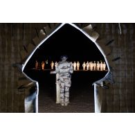 Le lieutenant Denis du 7e bataillon de chasseurs alpins (BCA) lit le récit des combats de la Sidi Brahim devant un marabout à Gao, au Mali.