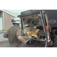 Dans une clinique près de Goma, débarquement d'une femme enceinte protégée par une couverture de survie sur un brancard depuis un véhicule de l'avant blindé sanitaire (VABSAN) du 1er régiment médical (1er RMed) de Metz par des casques bleus.