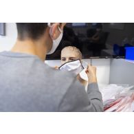 Un ingénieur de la DGA vérifie l'état général d'un masque sur la tête d'un mannequin au centre technique du Bouchet.