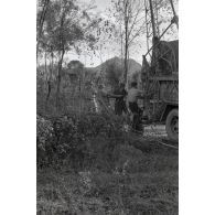 Dépannage d'une voiture par une grue Kfz-Aufsetzkran 3t installée sur un camion Opel Blitz.