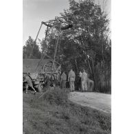 Dépannage d'une voiture par une grue Kfz-Aufsetzkran 3t installée sur un camion Opel Blitz.