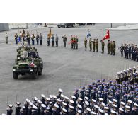 Sur la place de la Concorde, à bord d'un command-car, Emmanuel Macron, président de la République et le général d'armée François Lecointre, chef d'état-major des Armées (CEMA), passent les troupes en revue lors de la cérémonie du 14 juillet 2020.
