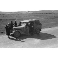 Une voiture Kfz-1 (Einheits-Personenkraftwagen Kfz.1) d'un convoi de ravitaillement en eau (Wasser-Kolonne 651) est entourée de civils libyens.