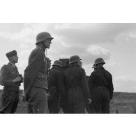 Des servants d'un télémètre de soutien, Kommandohilfsgeraet-35, au travail, sous la direction d'un Leutnant.