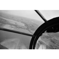 Au dessus de la Pologne, depuis la verrière nasale d'un bombardier Heinkel He-111, le survol d'un fleuve et d'un pont partiellement détruit.