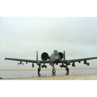 Avion d'appui rapproché Fairchild A-10 Thunderbolt-II armé au roulage avec pilote au cockpit sur la piste de la base aérienne américaine de CRK (camp du roi Khaled).