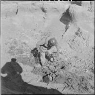 Un soldat du 81ème régiment d'infanterie (RI) près du corps du fellaga qu'il vient de tuer.