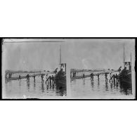 Le bois pour le vapeur est embarqué sur un chaland accosté au vapeur. [légende d'origine]