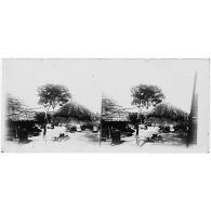 Cases indigènes - cuisine en plein air avec foyer, calebasse, pilon et vases. [légende d'origine]