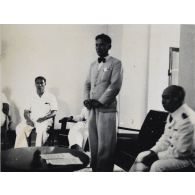 Dans le cadre de sa prestation de serment, le président Hoach se tient debout, en compagnie de hautes personnalités. [description provisoire]