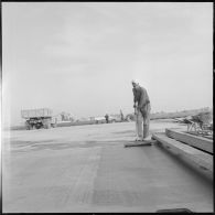 Aérodrome de Maison Blanche. Chantier de la nouvelle piste Est-Ouest en béton précontraint. Passage du balai en nylon.