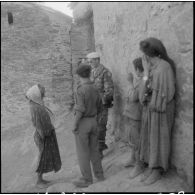 Section administrative spécialisée (SAS) d'Akourma. Dans le village de Tirarmine perdu dans le djebel, les moghaznis de la SAS discutent amicalement avec les habitants, femmes et enfants.