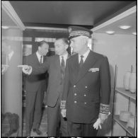 Inauguration de la foire exposition d'Oran. Pendant la visite monsieur Andrieu écoute les explications de son guide monsieur Le Portz.
