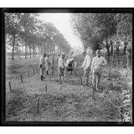 Nancy, des soldats posent du barbelé au bord du canal de Laneuville. [légende d'origine]