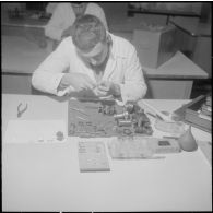 Camp de L'Alma (camp Bonvalot). Centre d'instruction du service du matériel n°3 (CISM n° 3). Un soldat travaillant sur des pièces en cours d'optique.