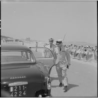Sidi Ferruch. Défilé de parachutistes. Les autorités militaires montent à bord d'une voiture Peugeot 403.