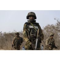 Un gendarme nigérien accompagne des marsouins du 3e régiment parachutiste d'infanterie de marine (RPIMa) pour le ratissage d'une zone boisée dans le secteur de Ouallam, au Niger.