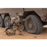 Un marsouin du 21e régiment d'infanterie de marine (RIMa) constate la crevaison des pneus d'un véhicule blindé multi-rôles (VBMR) Griffon à Gao, au Mali.