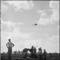 Arrivée d'un hélicoptère sanitaire Hiller pour évacuer un blessé au cours de l'opération Tourbillon VII. [description provisoire]