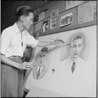 Préparation d'un panneau électoral à Vientiane par un peintre.