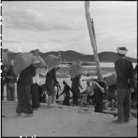 Transport des sacs de sel jusqu'aux jonques aux salines de Hon Khoi.