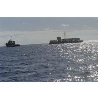 Remorquage de la barge Cimagré, chargée de l’obturation par cimentation du puits du Commissariat à l’énergie atomique (CEA), par le remorqueur ravitailleur Maroa (A637).