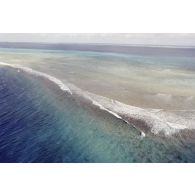 Vue aérienne du platier côté océan une heure après le troisième tir souterrain Aepytos du 27 octobre 1995 lors de la dernière campagne d'essais nucléaires dans le lagon de l'atoll de Moruroa.