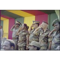 Officiers de l’armée zaïroise et officier français, le colonel parachutiste Gras, chef de la mission française d’assistance militaire au Zaïre, en  tribune officielle lors du défilé militaire à Lubumbashi. [Description en cours]