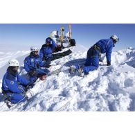L'équipe de secours du PGHM (peloton de gendarmerie de haute montagne) assiste la remontée d'une civière avec un blessé lors d'un exercice sur le Soum de Léviste, sommet des Hautes-Pyrénées situé à 2437 mètres d'altitude.