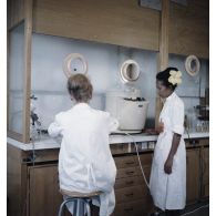 Portrait de deux laborantines étudiant les effets biologiques de l'atome au centre de contrôle biologique du centre technique (CT) de Mahina (Tahiti).