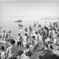 Fêtes du Juillet ou fête du Tiurai à Papeete en 1964. Course de pirogues. En arrière-plan, l'île de Moorea. [vue inversée]