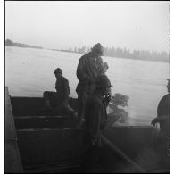 Des propulsistes du génie manoeuvrent des bateaux d'assaut M2 assemblés pour former une portière et transporter des véhicules sur le Rhin.