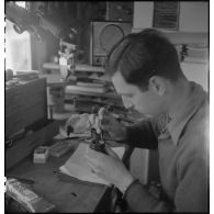 Camion atelier de réparation des appareils d'optique du groupe d'escadrons de réparation (GER XV) de la 2e division blindée (2e DB) : réparation d'une paire de jumelles.