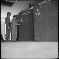 Un détenu du camp de concentration de Dachau libéré ouvre les caissons à gaz de la buanderie.