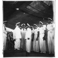 Dans le port de Saigon, lors d'une visite aux avisos "Le Chevreuil" et "La Gazelle" et à la frégate                  "Le Tonkinois", l'amiral Thierry d'Argenlieu passe en revue les troupes embarquées sur l'un des bâtiments. [description provisoire]