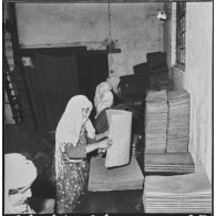 Aïn el Hadjar. Fabrique de papier. Pliage du papier par des femmes au format désiré.