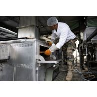 Un cuisinier prépare le repas à l'ordinaire de campagne de Vouziers.