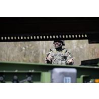 Un soldat du Service interarmées des munitions (SIMu) guide le chargement de caisses de munitions au moyen d'un chariot Manitou sur le camp de Vouziers.