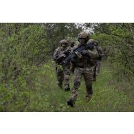 Des soldats belges des chasseurs ardennais progressent en forêt de Suippes.