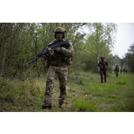 Des soldats belges des chasseurs ardennais progressent en forêt de Suippes.