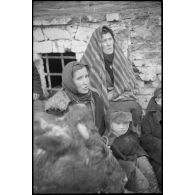 Dans et contre une isba, des femmes, des enfants et des hommes âgés assistent à la lente retraite des fantassins allemands.