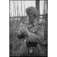 Portrait d'un fantassin allemand portant un oiseau dans ses bras.