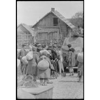 Durant l'opération Frühlingfest, des travailleurs forcés (Zwangarbeiter) accompagnent sous la contrainte des blindés légers allemands Panzer II.