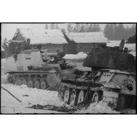 Un Sd.kfz.124 "Wespe" passe devant un char soviétique T-34 détruit.