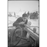 Un fantassins se rase en s'aidant d'un rétro-viseur d'un véhicule amphibie Schwimmwagen.