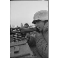 Tireur et pourvoyeur derrière une mitrailleuse MG-34 en pleine action.