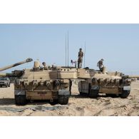 Des soldats du 5e régiment de cuirassiers (RC) interviennent sur leurs chars de combat AMX-Leclerc pour leur maintenance sur le camp d'Al Hamra, aux Emirats arabes unis.