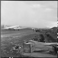 Lors de l'évacuation du camp retranché de Na San, une grande quantité de caisses et de matériel est stocké en bordure de la piste d'aviation.