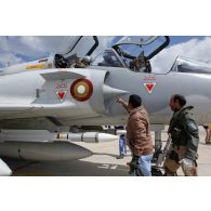 Avant le départ en mission, un pilote qatari effectue la visite de contrôle avant vol de son avion Mirage 2000-5 QA 85 avec son mécanicien de piste : vérification d'une tuyère.